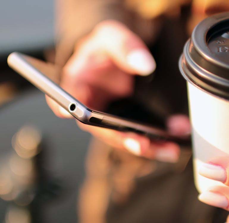Staff member using a phone at the counter