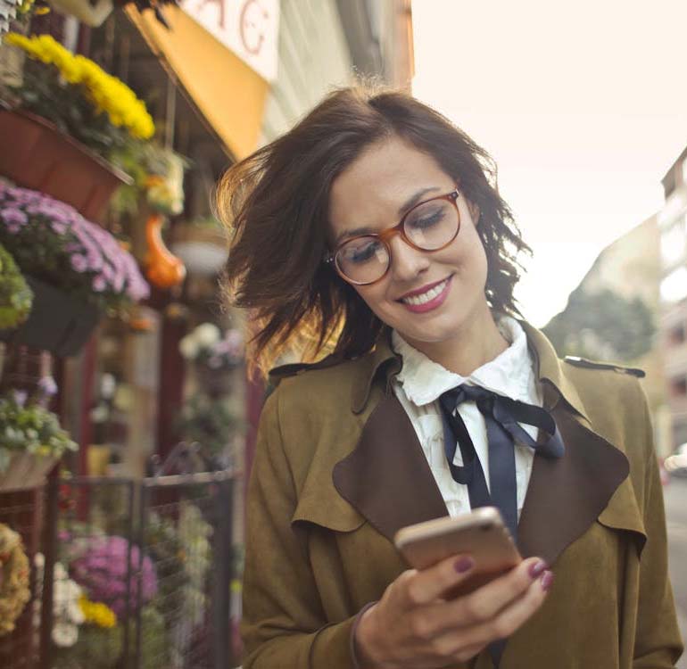 Woman smiling at her phone
